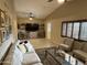 Spacious living room features a ceiling fan, tile floors, large TV, and comfortable seating at 3341 W Windrose Dr, Phoenix, AZ 85029