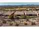 Aerial view of a home showcasing lush landscaping, a patio area, and proximity to the golf course at 41515 N Laurel Valley Way, Anthem, AZ 85086