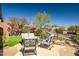 A backyard featuring a patio area, lush landscaping, and comfortable outdoor furniture at 41515 N Laurel Valley Way, Anthem, AZ 85086