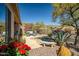 Landscaped backyard features a pool, a rock waterfall, lush plantings and outdoor seating on a paver patio at 41515 N Laurel Valley Way, Anthem, AZ 85086