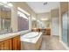 Bright bathroom featuring a soaking tub, double sinks and walk-in shower at 41515 N Laurel Valley Way, Anthem, AZ 85086