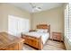 Comfortable bedroom with wood floors, ceiling fan, and natural light at 41515 N Laurel Valley Way, Anthem, AZ 85086