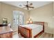 Bedroom with wood flooring, wood bed frame and matching dressers, and shuttered window at 41515 N Laurel Valley Way, Anthem, AZ 85086