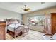 Well-lit bedroom featuring hardwood floors, large windows and an ornate wood furniture set at 41515 N Laurel Valley Way, Anthem, AZ 85086