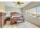 Spacious bedroom featuring hardwood floors, a ceiling fan and large bright windows at 41515 N Laurel Valley Way, Anthem, AZ 85086