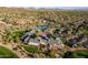 Overhead view of a well-maintained community with a pool, tennis courts, and golf course set against a desert backdrop at 41515 N Laurel Valley Way, Anthem, AZ 85086