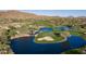 Scenic aerial view of the golf course, featuring lush green fairways, sparkling water features, and mountain views at 41515 N Laurel Valley Way, Anthem, AZ 85086