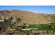 An aerial view of a verdant golf course with mountain views, native desert plants, and sand traps at 41515 N Laurel Valley Way, Anthem, AZ 85086