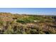 Aerial view of a lush golf course with desert landscaping and mountain views in the distance at 41515 N Laurel Valley Way, Anthem, AZ 85086