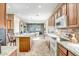 Bright kitchen featuring a large island, custom wood cabinetry, granite countertops, and open floor plan at 41515 N Laurel Valley Way, Anthem, AZ 85086
