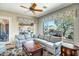 Comfortable living room featuring a large sectional sofa and views of the backyard at 41515 N Laurel Valley Way, Anthem, AZ 85086