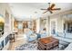 Spacious and airy living room with tile floors, ceiling fan, and easy access to the kitchen at 41515 N Laurel Valley Way, Anthem, AZ 85086