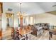 Bright living room and dining area with wood floors and neutral color palette at 41515 N Laurel Valley Way, Anthem, AZ 85086