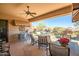 A covered patio area with outdoor furniture and views of the pool and landscaped backyard at 41515 N Laurel Valley Way, Anthem, AZ 85086