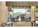 Window view overlooking a scenic outdoor patio with seating and mountain views in the distance at 41515 N Laurel Valley Way, Anthem, AZ 85086