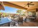 Covered patio overlooking a well landscaped backyard with a pool and mountain views at 41515 N Laurel Valley Way, Anthem, AZ 85086