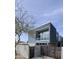 Modern home featuring corrugated metal siding and large windows, complemented by a desert landscape and secure gated entry at 4410 N 27Th St # 5, Phoenix, AZ 85016