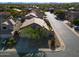 Aerial view of a well-maintained home with mature landscaping and a paved driveway, and neighborhood at 4415 E Weaver Rd, Phoenix, AZ 85050