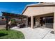 Relaxing backyard patio with a custom fireplace, paved area, and an outdoor kitchen at 4415 E Weaver Rd, Phoenix, AZ 85050