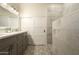 Modern bathroom featuring double vanity, designer tile flooring, and a frameless glass shower at 4415 E Weaver Rd, Phoenix, AZ 85050