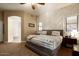 Serene bedroom featuring a patterned accent wall, neutral bedding, and ample natural light at 4415 E Weaver Rd, Phoenix, AZ 85050