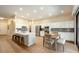 Bright kitchen with stainless steel appliances, granite counters, island, and dining area at 4415 E Weaver Rd, Phoenix, AZ 85050