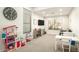 Bright playroom with a TV, toy storage, table, and large clock at 4415 E Weaver Rd, Phoenix, AZ 85050