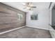 Bedroom with wood accent wall and ceiling fan at 4425 E Glenrosa Ave, Phoenix, AZ 85018