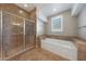 Bathroom with shower, soaking tub and tile flooring at 5519 W Big Oak St, Phoenix, AZ 85083