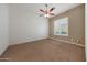 Bright bedroom with ceiling fan and plush carpeting at 5519 W Big Oak St, Phoenix, AZ 85083