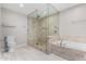 Spa-like bathroom featuring a glass-enclosed shower and a soaking tub at 6604 W Evans Dr, Glendale, AZ 85306