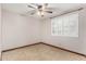 Well-lit bedroom with ceiling fan, shuttered window, and tile flooring at 6604 W Evans Dr, Glendale, AZ 85306