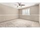Neutral bedroom featuring plush carpeting, a ceiling fan, and bright, shuttered windows at 6604 W Evans Dr, Glendale, AZ 85306