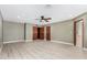 Large bedroom with light wood floors, ceiling fan, and ensuite bathroom access at 6604 W Evans Dr, Glendale, AZ 85306