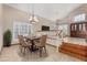 Open-concept dining room with chandelier, adjacent to the staircase and entry at 6604 W Evans Dr, Glendale, AZ 85306