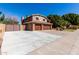 Two-story brick home with a three-car garage and an expansive driveway at 6604 W Evans Dr, Glendale, AZ 85306