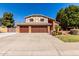 Charming two-story home with three-car garage, manicured lawn, and mature trees at 6604 W Evans Dr, Glendale, AZ 85306