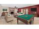 Spacious game room with a pool table, fireplace, and comfortable seating for entertainment at 6604 W Evans Dr, Glendale, AZ 85306