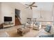 Bright living room features high ceilings, a ceiling fan, and comfortable seating near the staircase at 6604 W Evans Dr, Glendale, AZ 85306