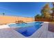 Backyard pool with waterfall feature and brick paved patio at 6604 W Evans Dr, Glendale, AZ 85306