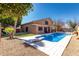 Backyard showcasing a private pool with a diving board, complemented by desert landscaping at 6604 W Evans Dr, Glendale, AZ 85306