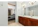 Ensuite bathroom features dual sinks, dark wood cabinetry, and tiled floors at 6605 N 93Rd Ave # 1101, Glendale, AZ 85305