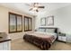 Comfortable bedroom with natural light, ceiling fan, and art on the walls at 6605 N 93Rd Ave # 1101, Glendale, AZ 85305