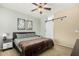 Relaxing bedroom featuring a ceiling fan, large windows, and a comfortable bed at 6605 N 93Rd Ave # 1101, Glendale, AZ 85305