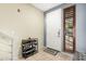 Inviting entryway with tile flooring, a shoe rack, and a shuttered window at 6605 N 93Rd Ave # 1101, Glendale, AZ 85305