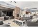 Spacious living room featuring a fireplace, fan and a comfortable seating area at 6605 N 93Rd Ave # 1101, Glendale, AZ 85305