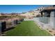 Landscaped backyard with artificial grass and a fountain feature at 6825 N 39Th Pl, Paradise Valley, AZ 85253