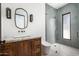 Modern bathroom featuring a wood vanity, shower with gray tile, and contemporary fixtures at 6825 N 39Th Pl, Paradise Valley, AZ 85253