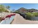 Long winding driveway with red brick and lush desert landscaping and mountain views at 6825 N 39Th Pl, Paradise Valley, AZ 85253