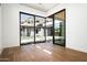 Open living space with wood floors and an expansive window with a view of the yard and pool at 6825 N 39Th Pl, Paradise Valley, AZ 85253